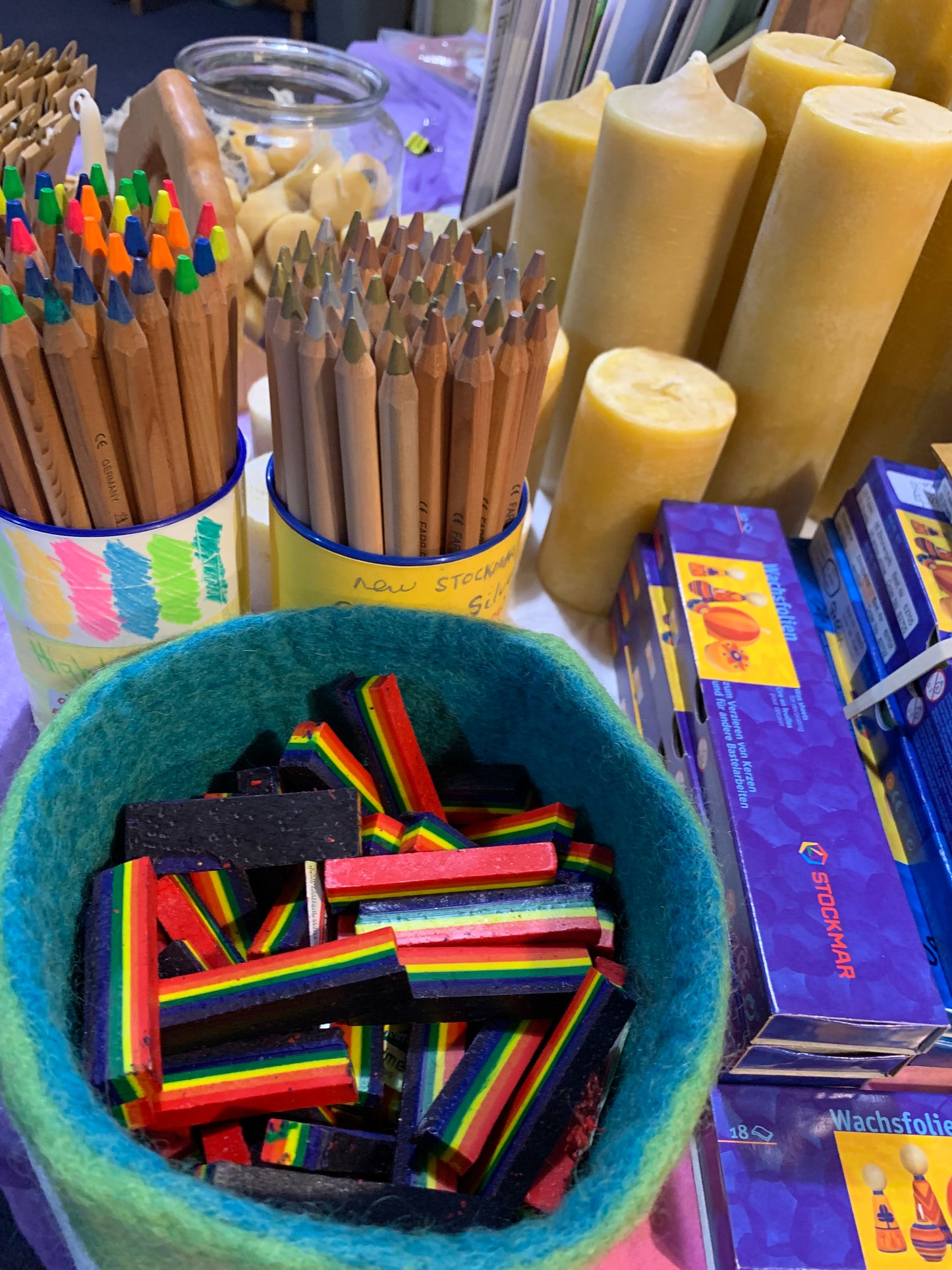 Rainbow crayons amongst other products on display at a fair