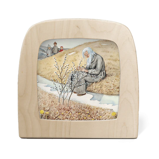 A wooden silhouette screen featuring an illustration of childrena observing a seated tired old man at the end of Winter, with a pussy willow tree in the foreground