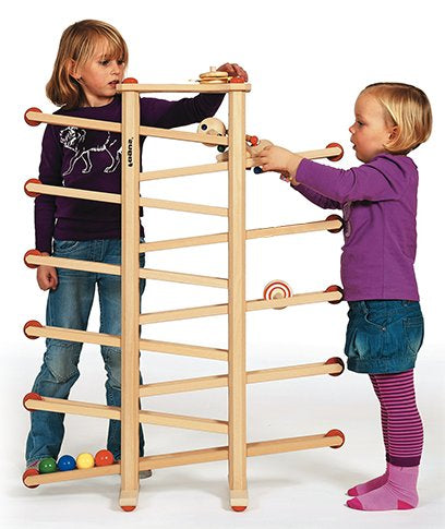 Two children playing with a wooden marble ball track toy on a white background