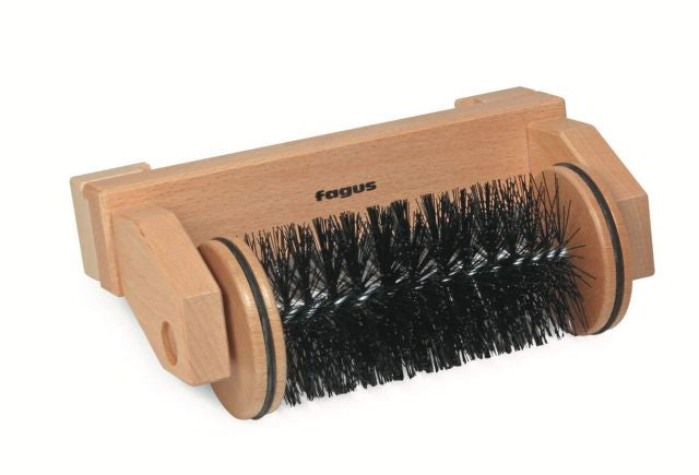 Wooden brush sweeper with black bristles on a white background