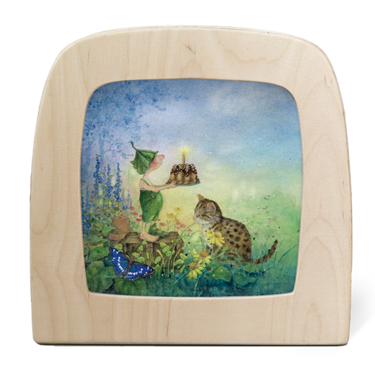 Griswald the gnome presents a birthday cake in the cottage garden