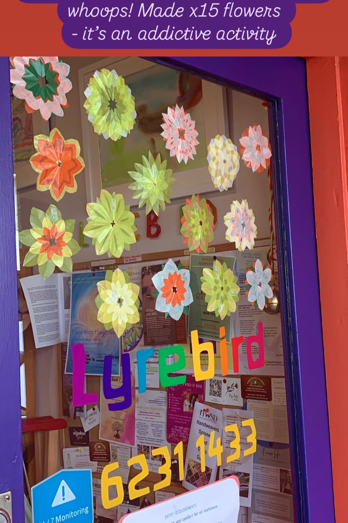 kite paper daffodil inspired flowers on our shop door  in late Winter