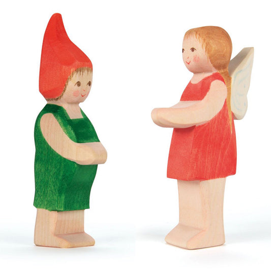 Two new cute wooden figures from Ostheimer ; one an elf with a red pointy cap and green overalls, and a fairy with a red pinafore frock and wings