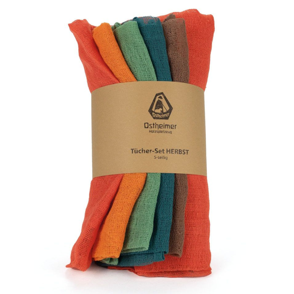 Set of five colourful muslin cotton cloths with a branded label on a white background