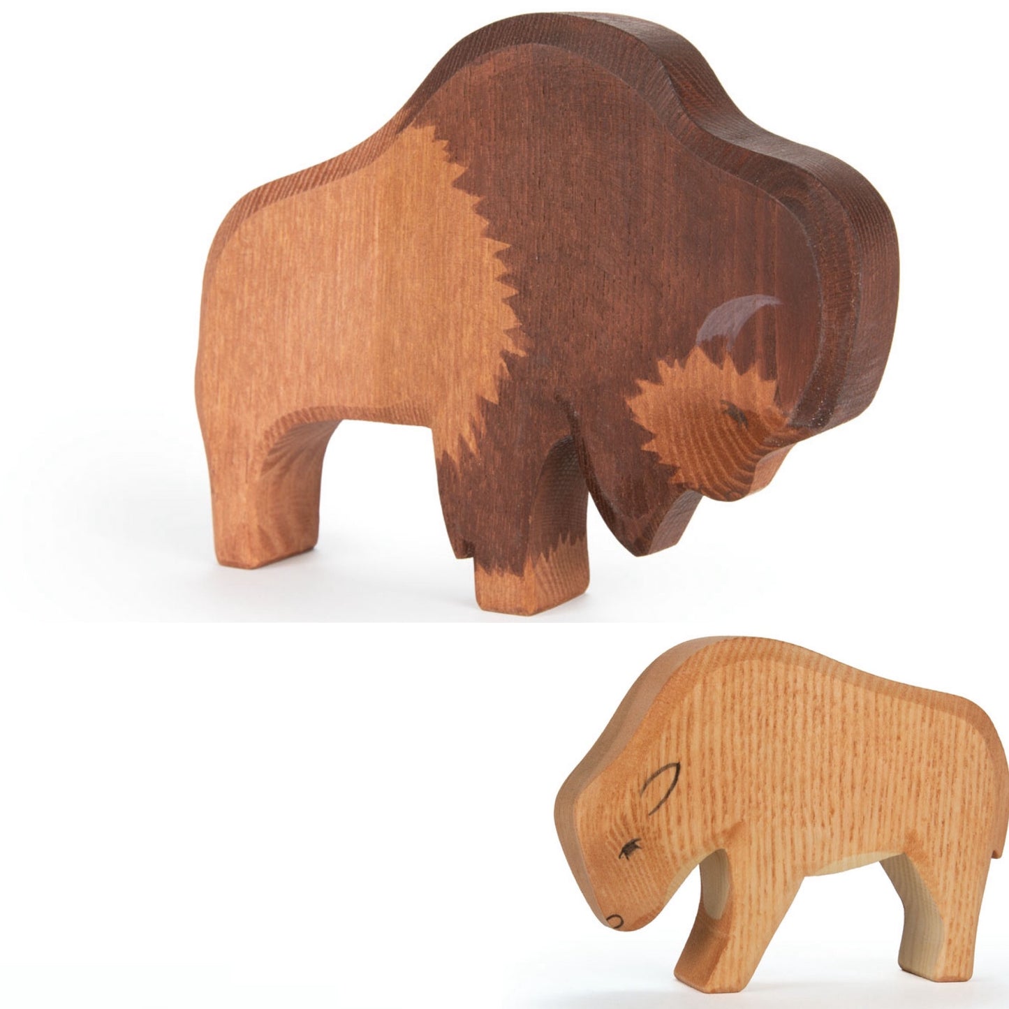 Two wooden buffalo figurines on a white background