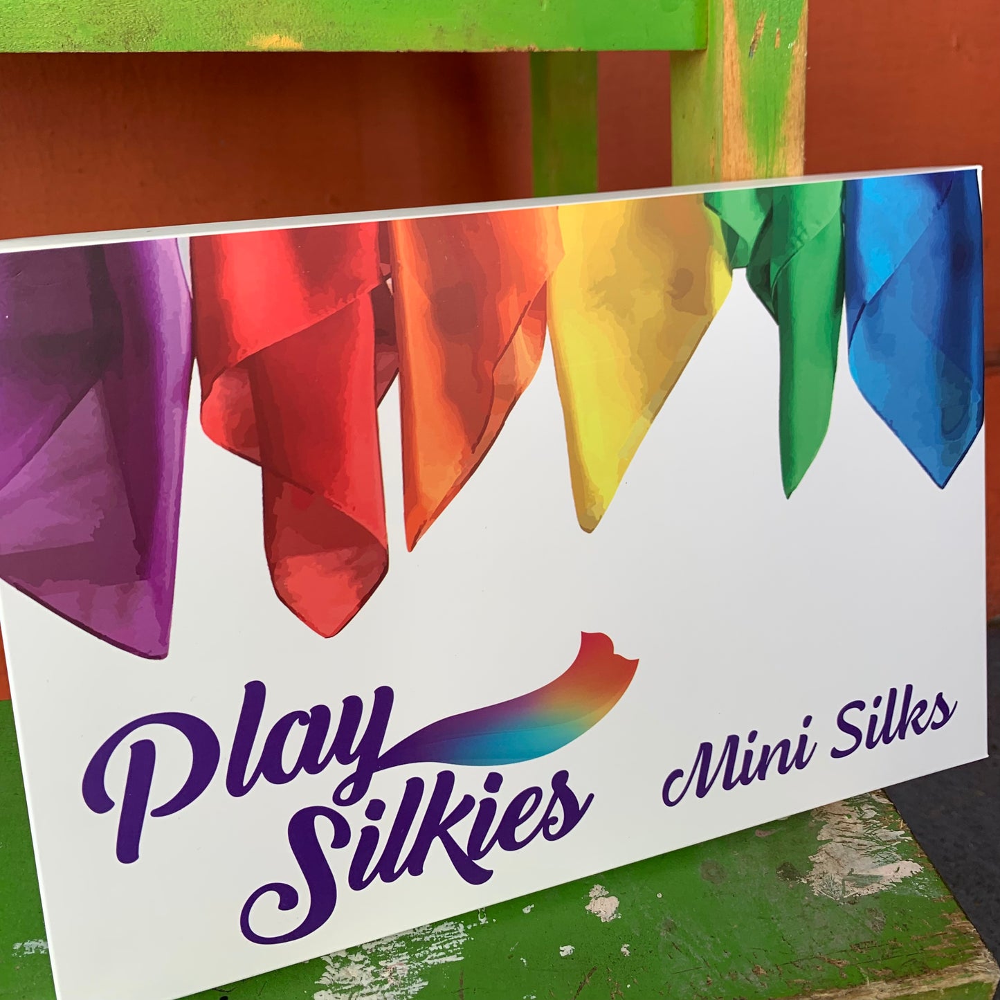 Colourful mini silks packaging with 'Play Silkies Mini Silks' branding on a white background.