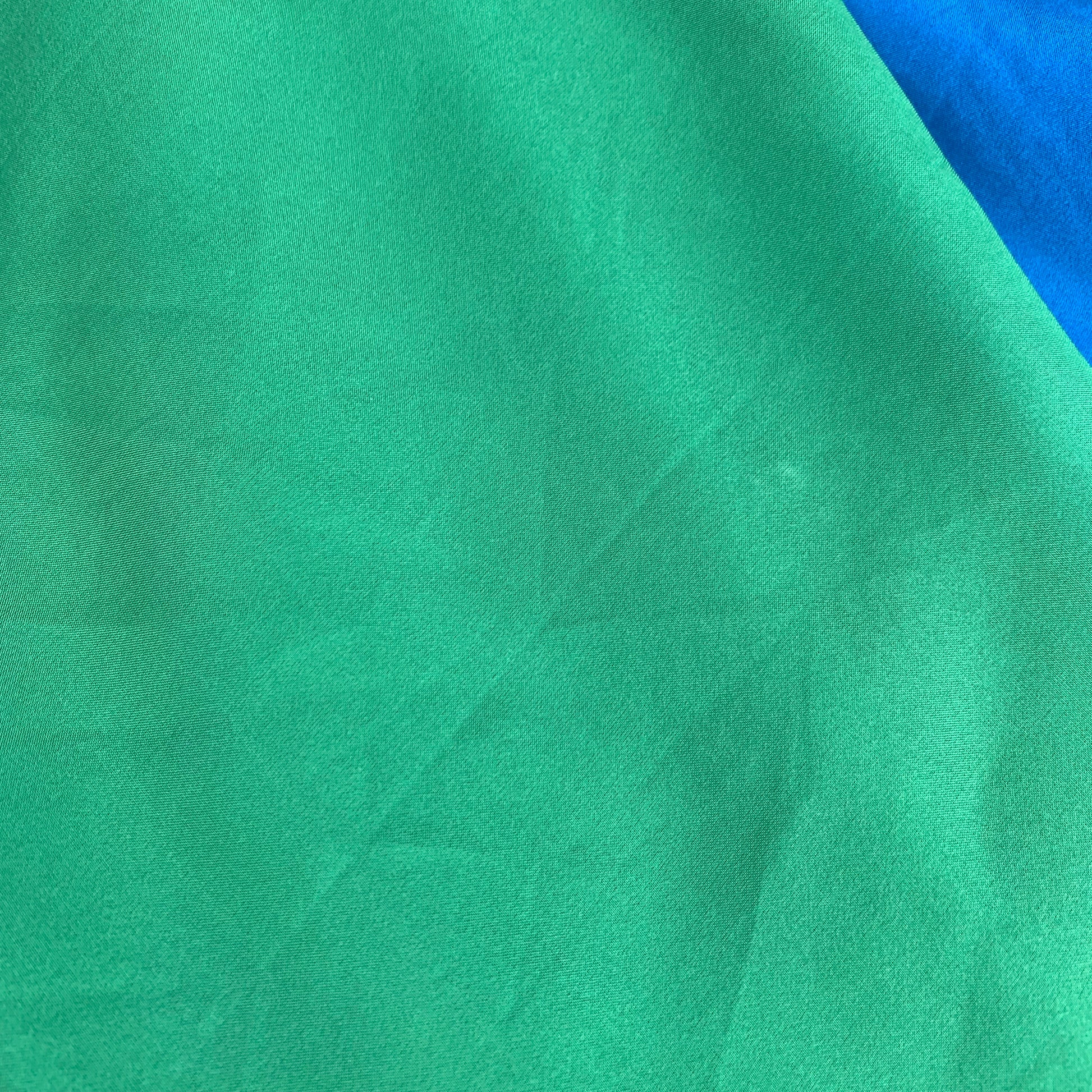 Close-up of green silk fabric play silk