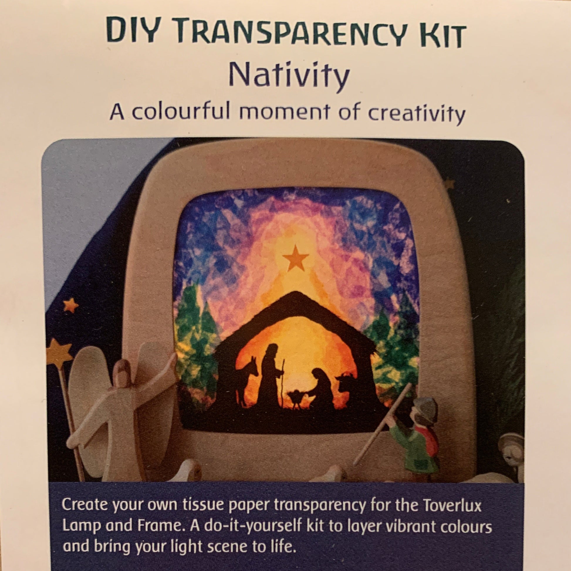 Cardboard packaging of a DIY transparency kit with a Nativity scene design.