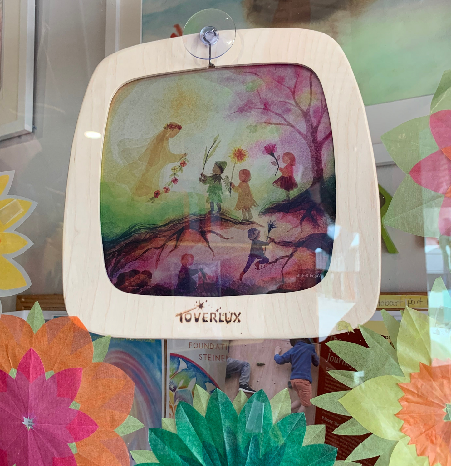 the Toverlux frame attaches easily and securely to the window with the hook on a suction cap