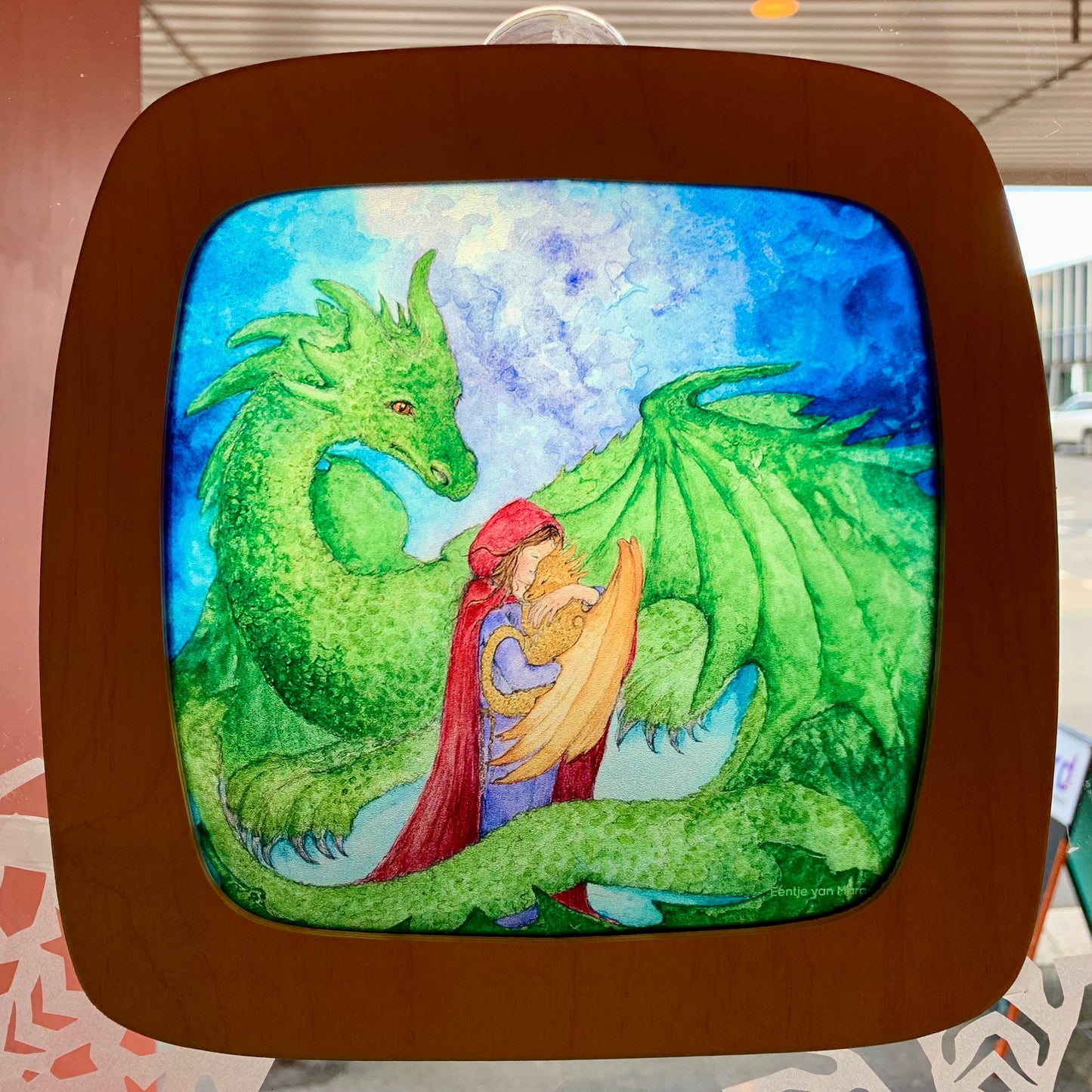 Toverlux window frame attached to a window in a door, the natural  daylight behind illuminates the silhouette screen