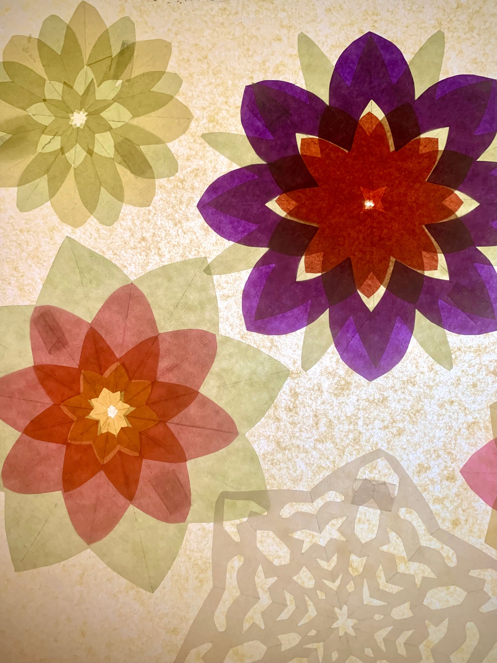 kite paper has been folded, cut and glued to make pretty floral window decorations