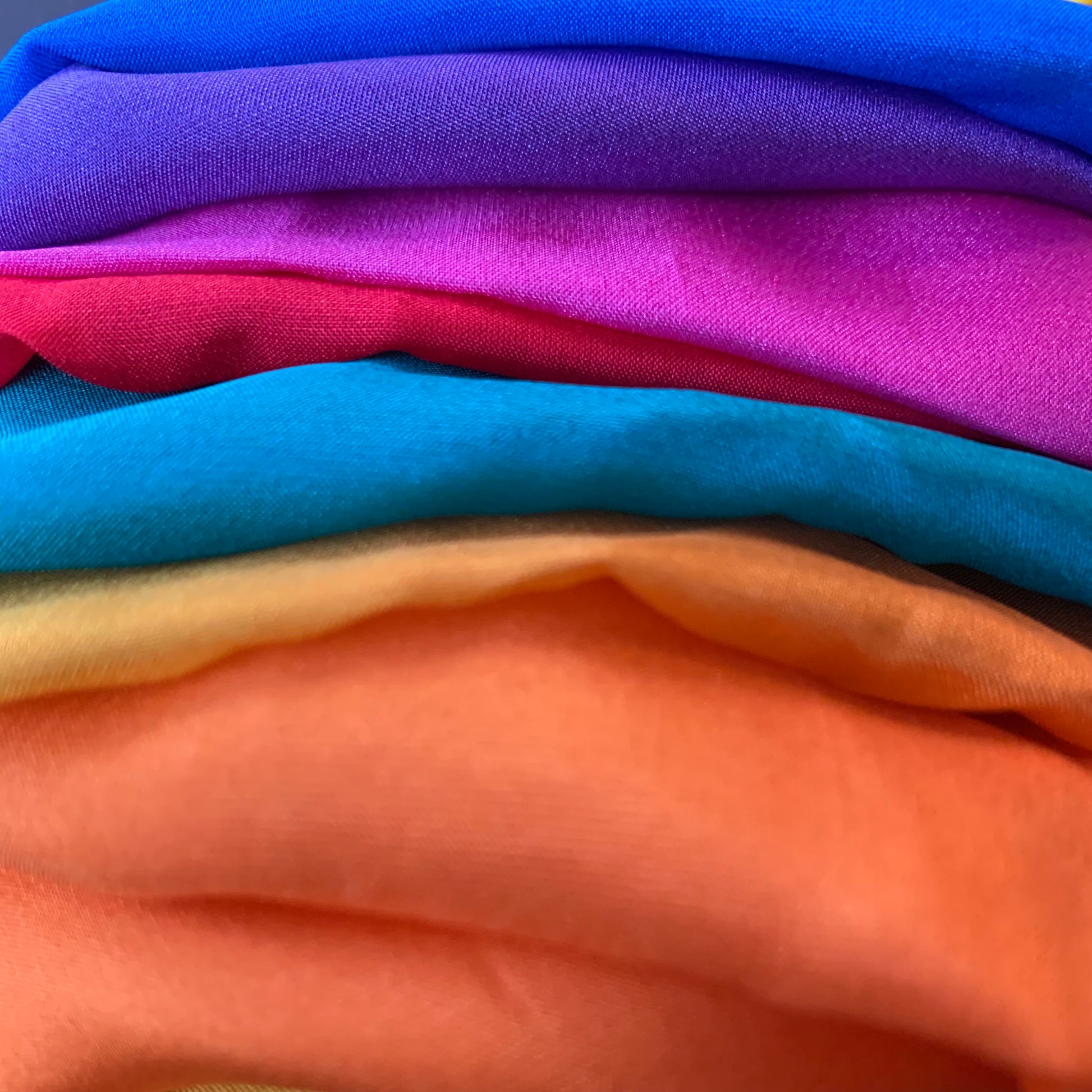 a rainbow silk play cloth bunched up into folds