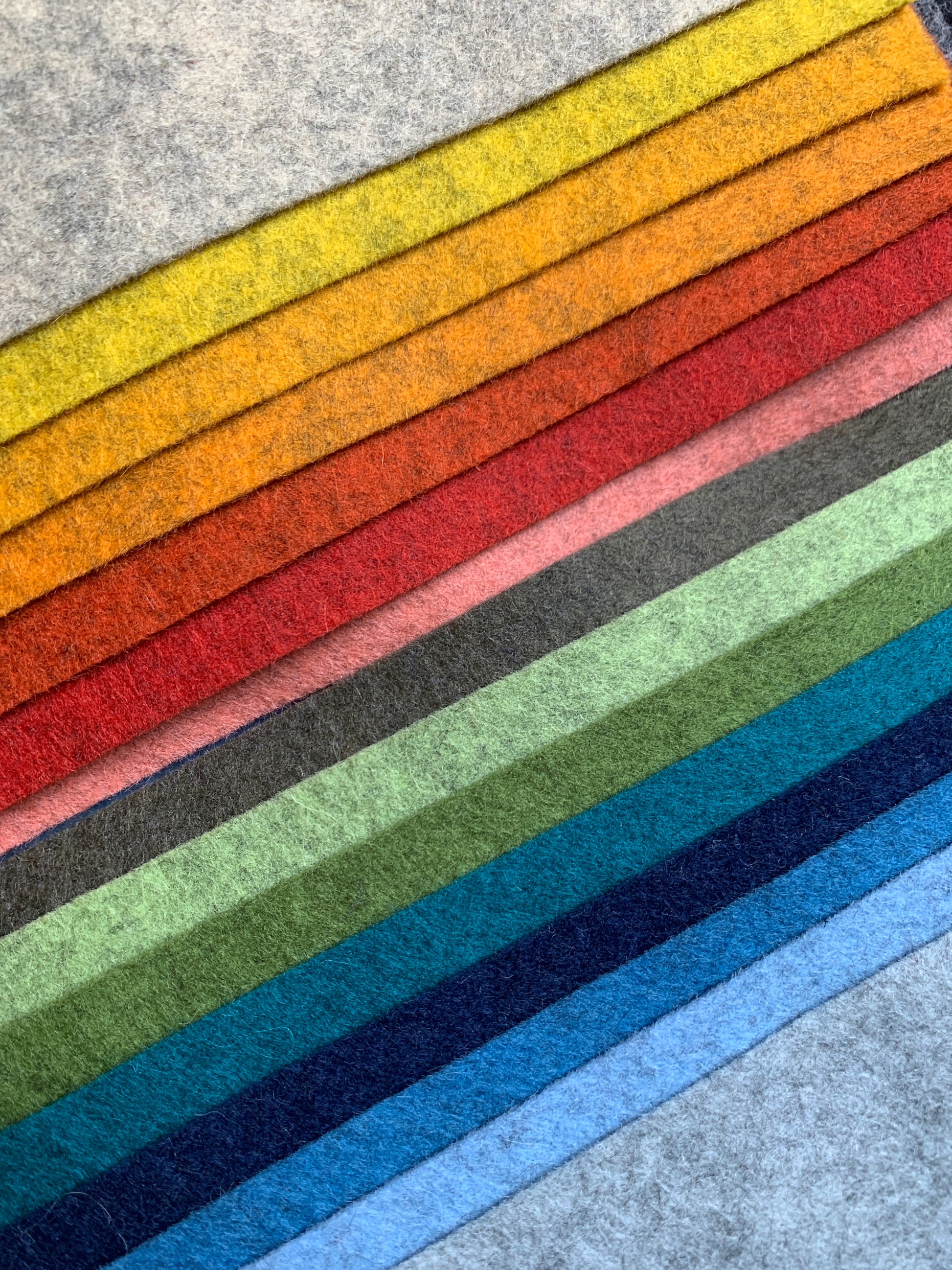 a selection of x15 shades of 100% pure wool felt in mottled (heathered) texture