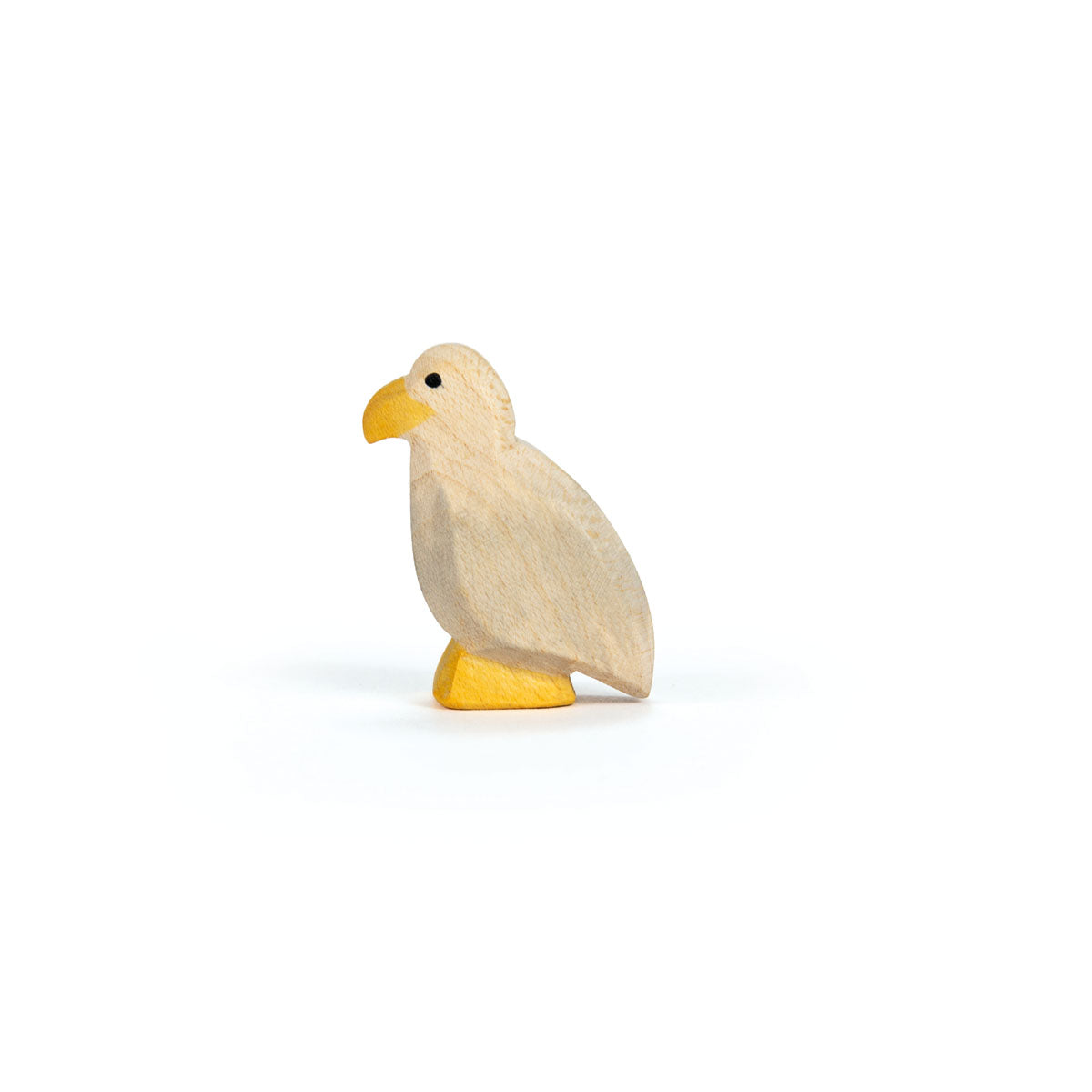 Wooden bird figurine with a yellow beak and feet on a white background