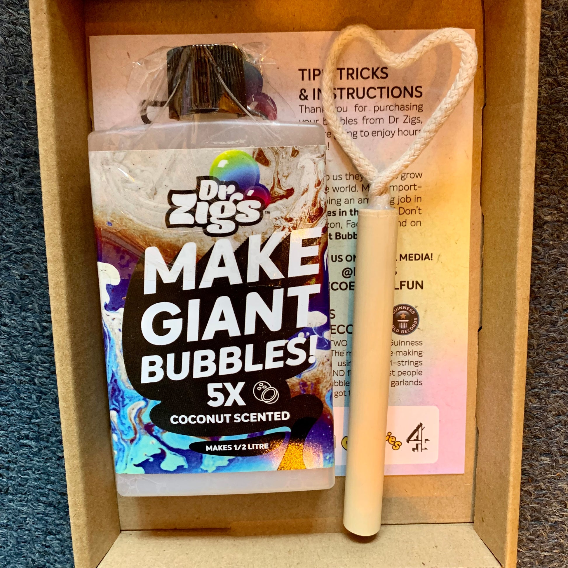 Dr. Zigs bubble solution packaging with a bubble wand in a cardboard box.