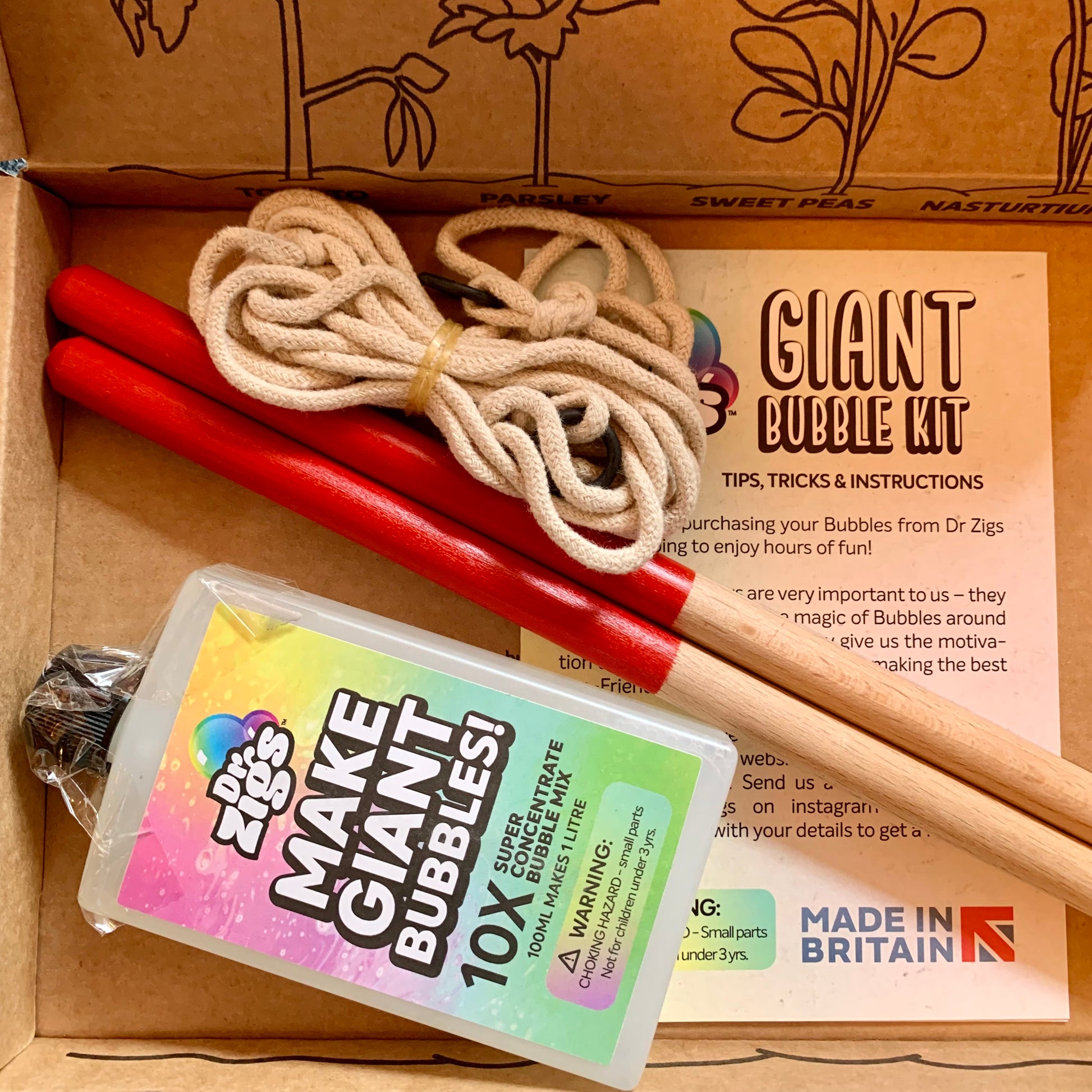 Multi bubble kit with sticks, rope, and concentrate mix in a cardboard box.