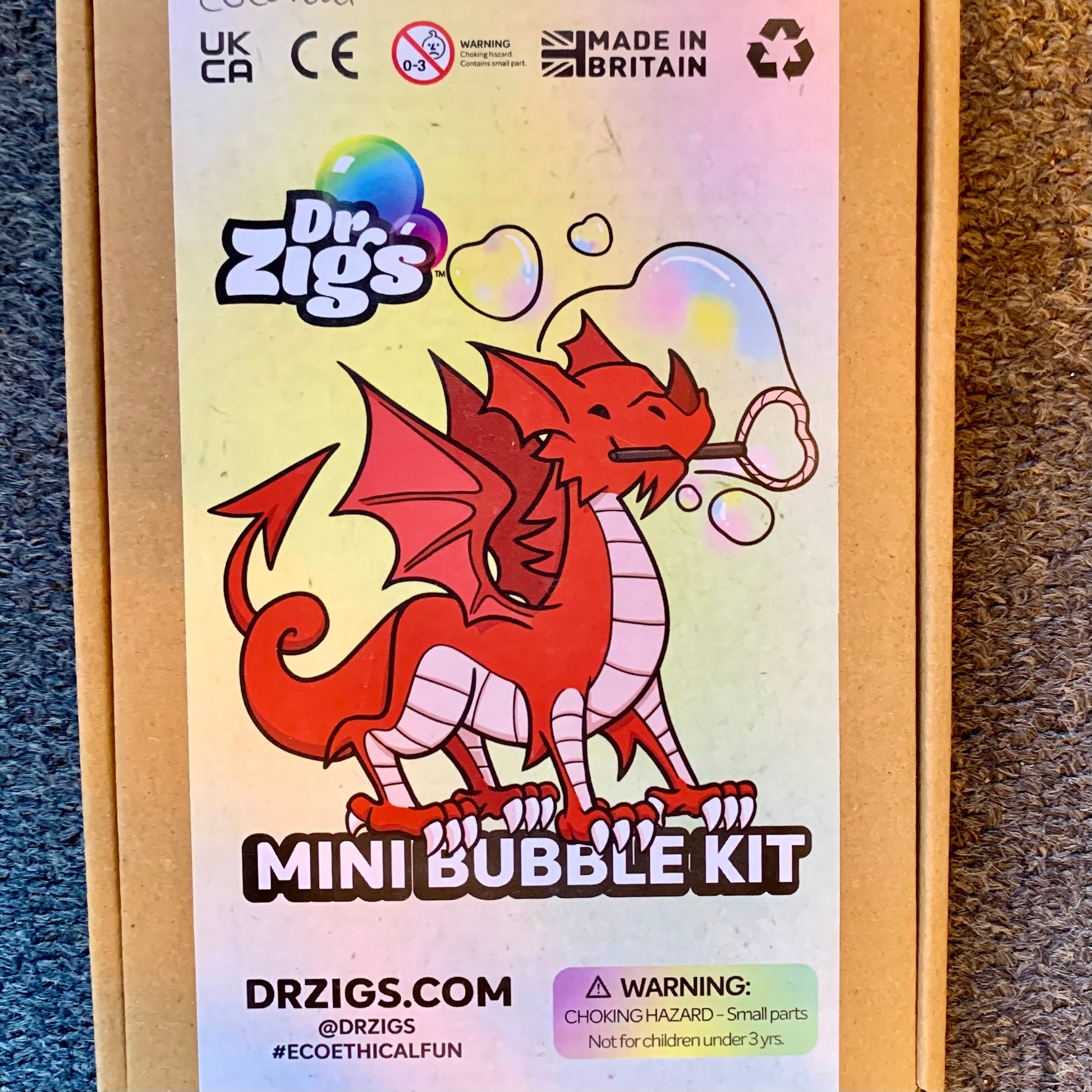 Dr. Zig's Mini Bubble Kit packaging with a red dragon illustration on a multicolored background.
