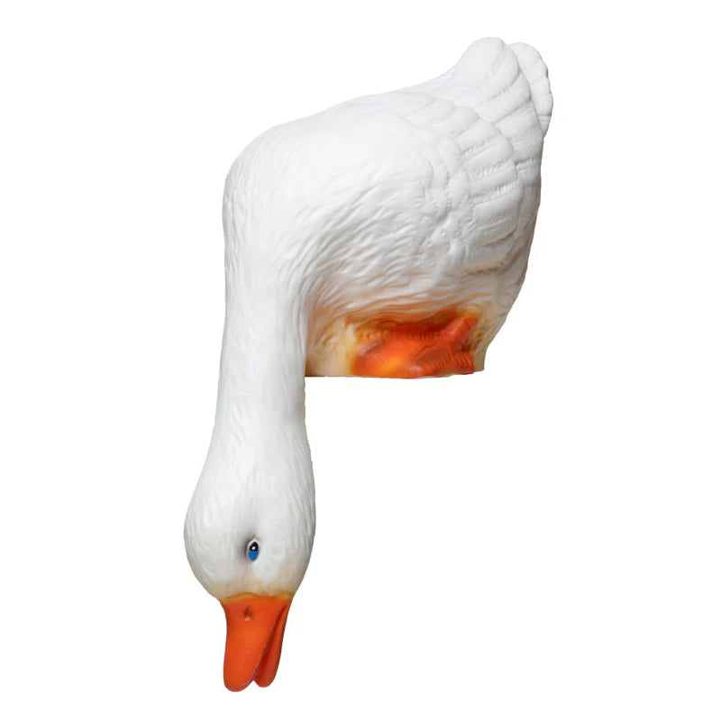 A night lamp in the shape of a life sized white duck looking down from the shelf 