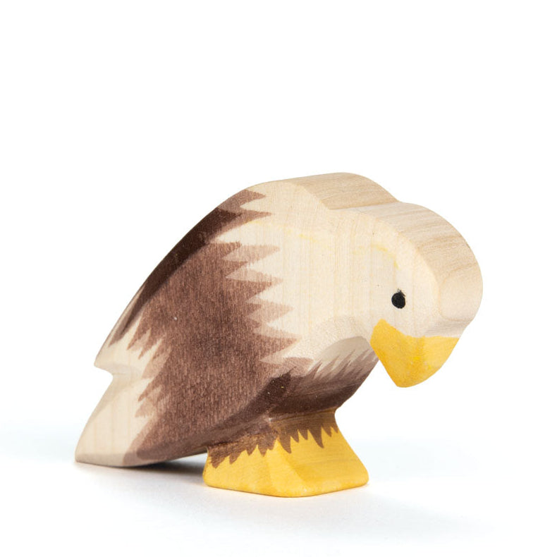 Wooden duck toy with brown and beige coloring on a white background