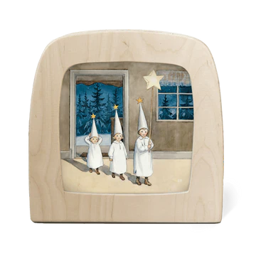  Wooden frame with three children in night gowns  set against a window with night sky wearing star hats