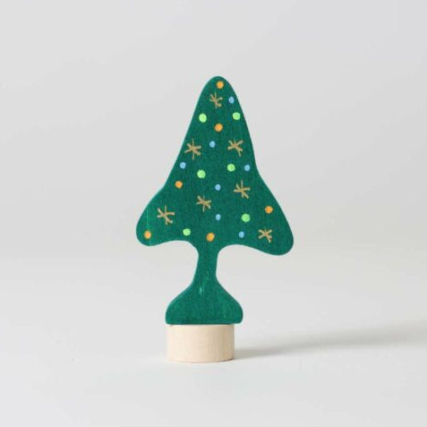 Green wooden Christmas tree ornament with star patterns on a white background