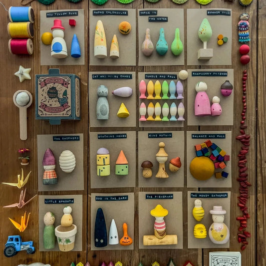 Collection of colourful figurines and on a wooden surface