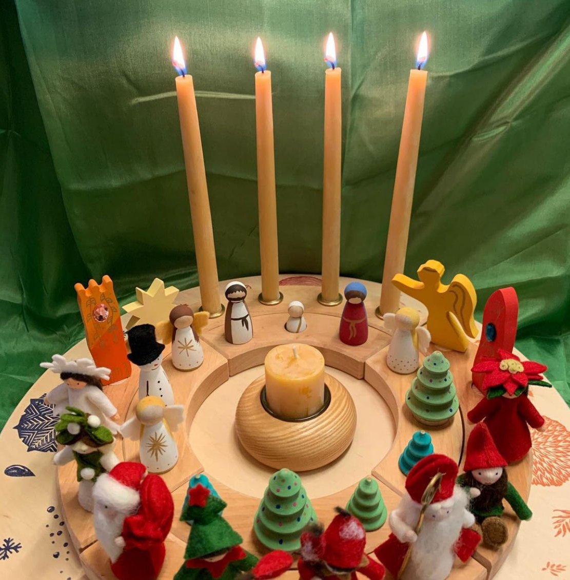 Celebration ring for Advent showing two rings with 4 holes for advent candles, and 24 holes to count down, then a large candle placed on Christmas day