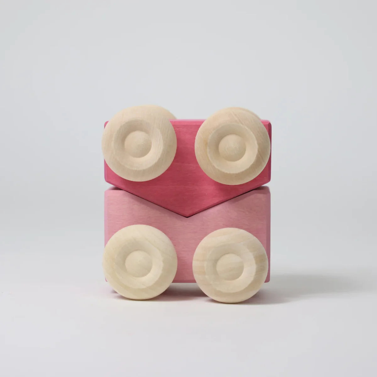 Pink pair of stacking cars with wooden wheels on a light grey background