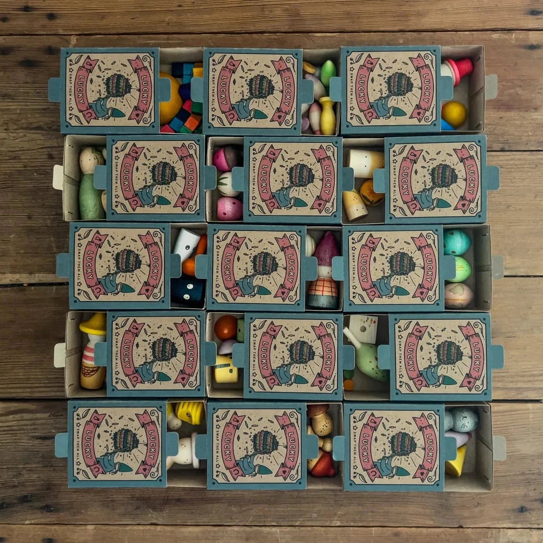 Grid of small boxes with colourful wooden contents on a wooden surface