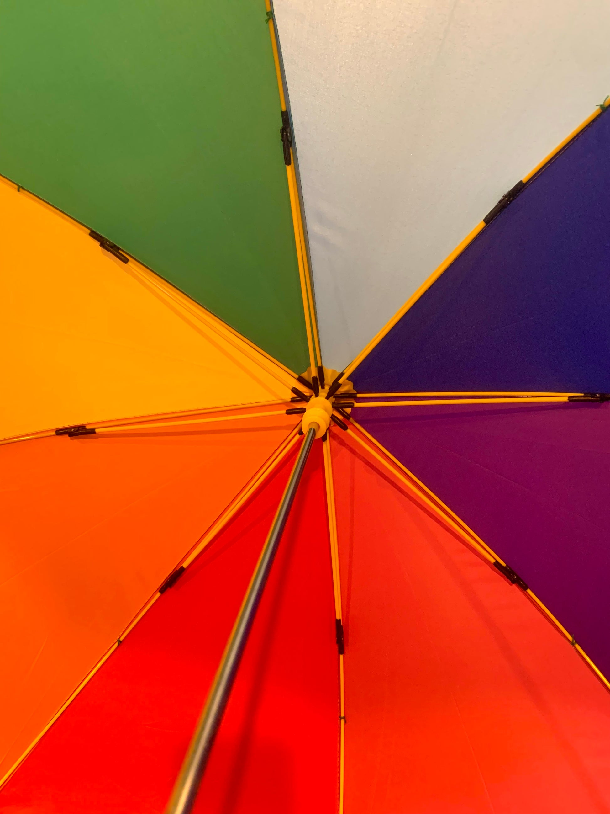 Inside view of Colourful rainbow childs umbrella with a rainbow selection of panels