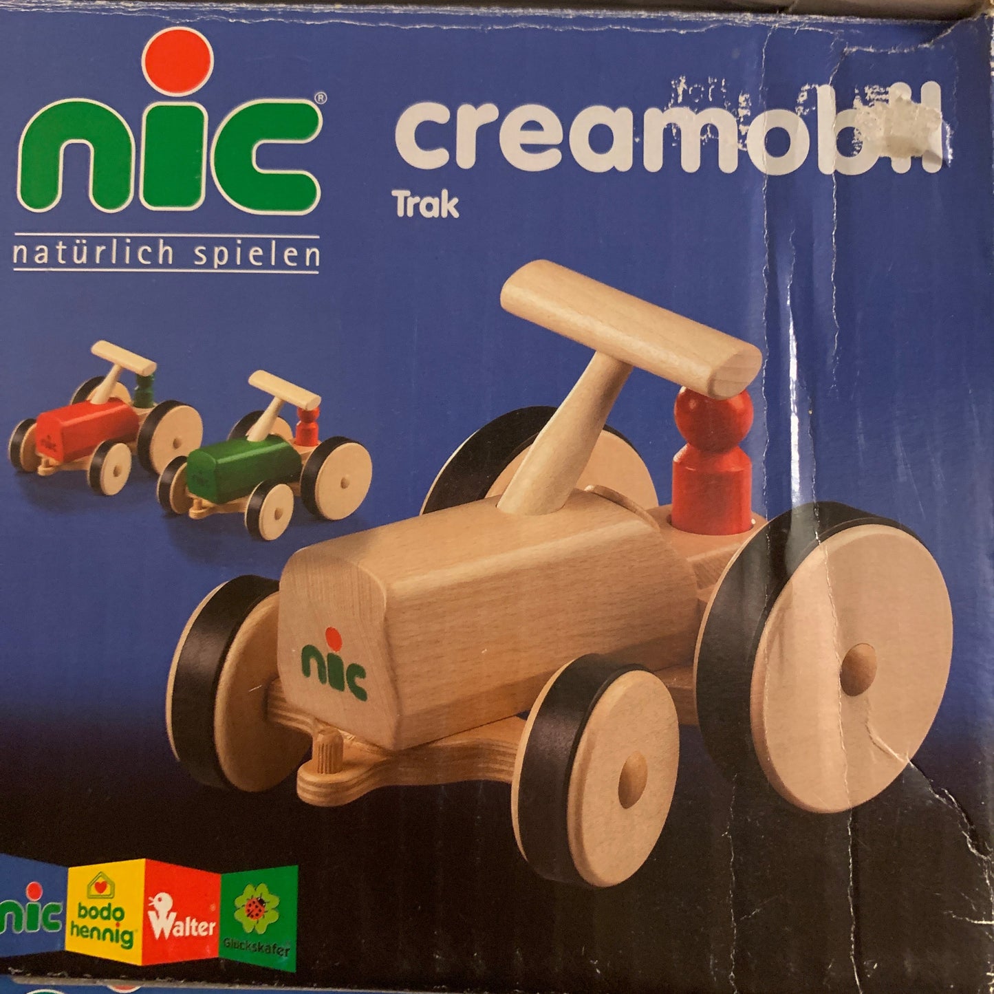 Wooden toy Creamobile tractor on a Nic branded box