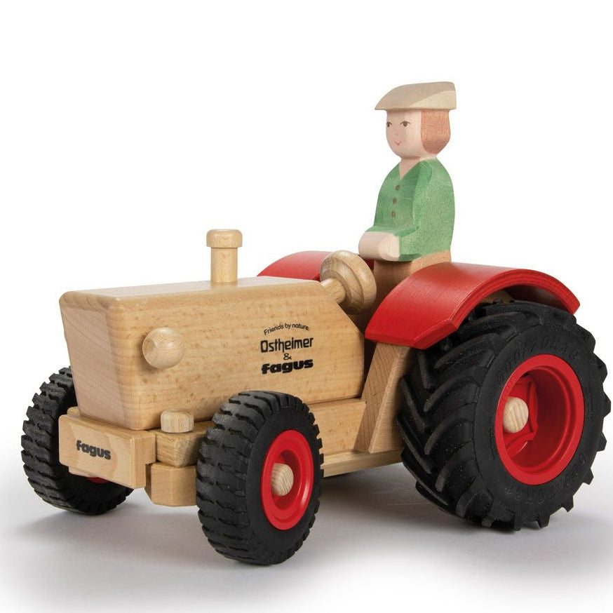 Wooden toy tractor with a driver figure on a white background