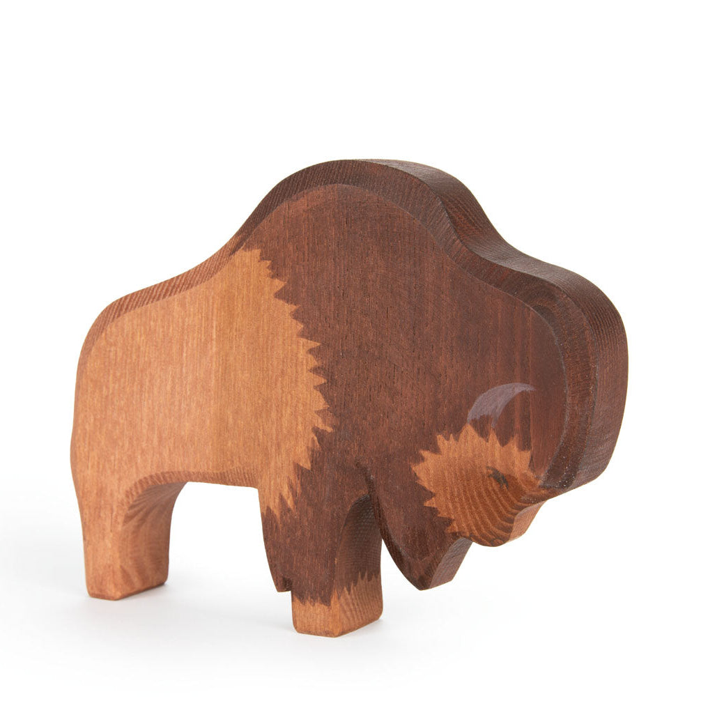 Wooden buffalo figurine on a white background
