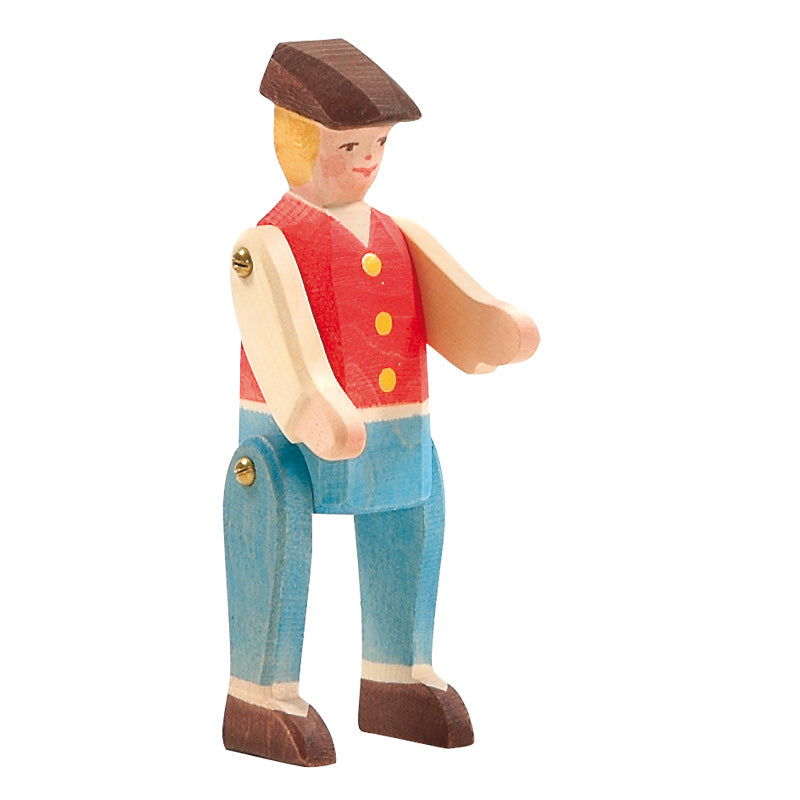 Wooden toy figure of ahorse rider wearing a red vest with yellow buttons and blue pants wearing a cap on a white background