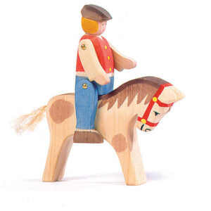 Wooden toy figure of a person riding a horse on a white background