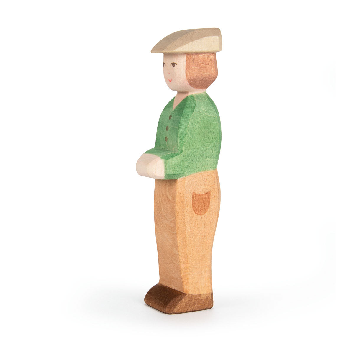 Wooden figurine of a person wearing a green shirt and beige hat on a white background