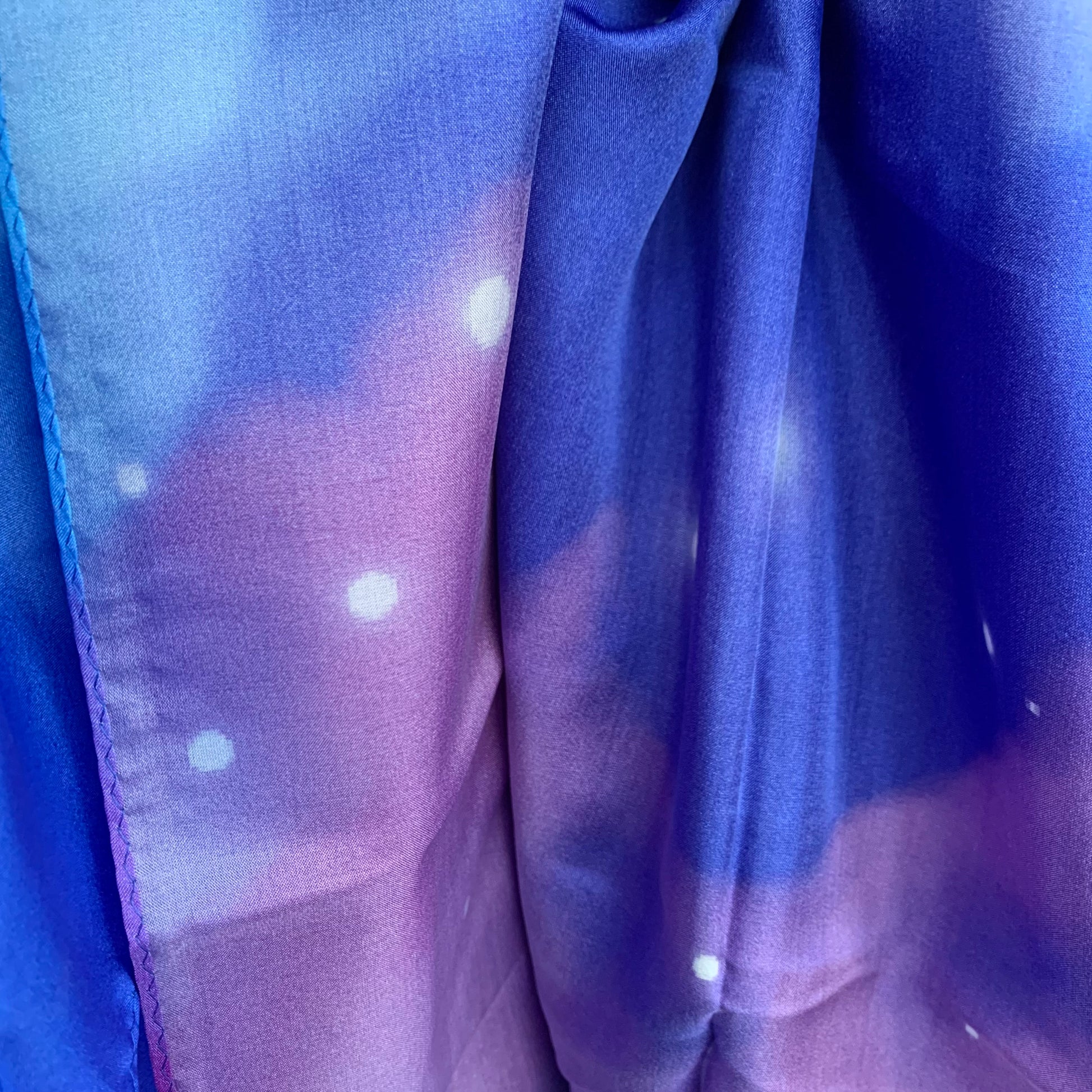 Close-up of jumbo purple and blue silk fabric with stars 