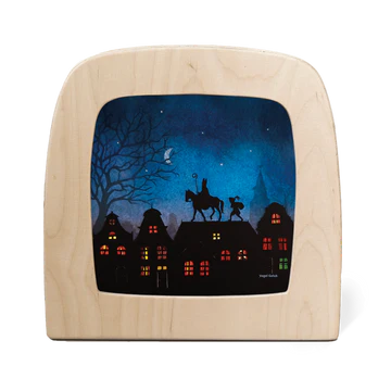 Wooden picture frame with a silhouette night scene of a horse and  St Nicholas, houses with lit windows, trees and moon