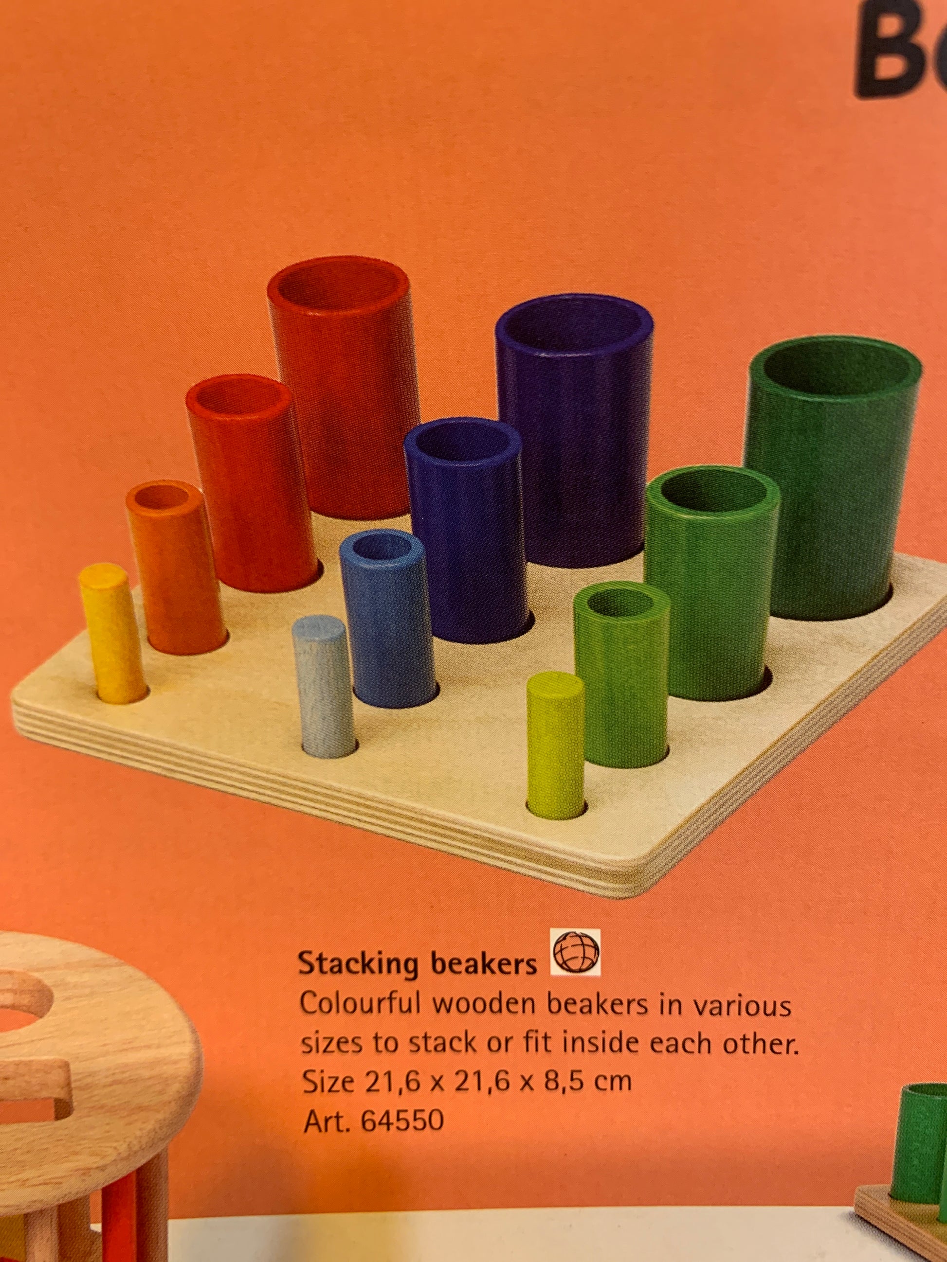 Wooden stacking beakers set on a timber sorting tray on an orange background with product details.