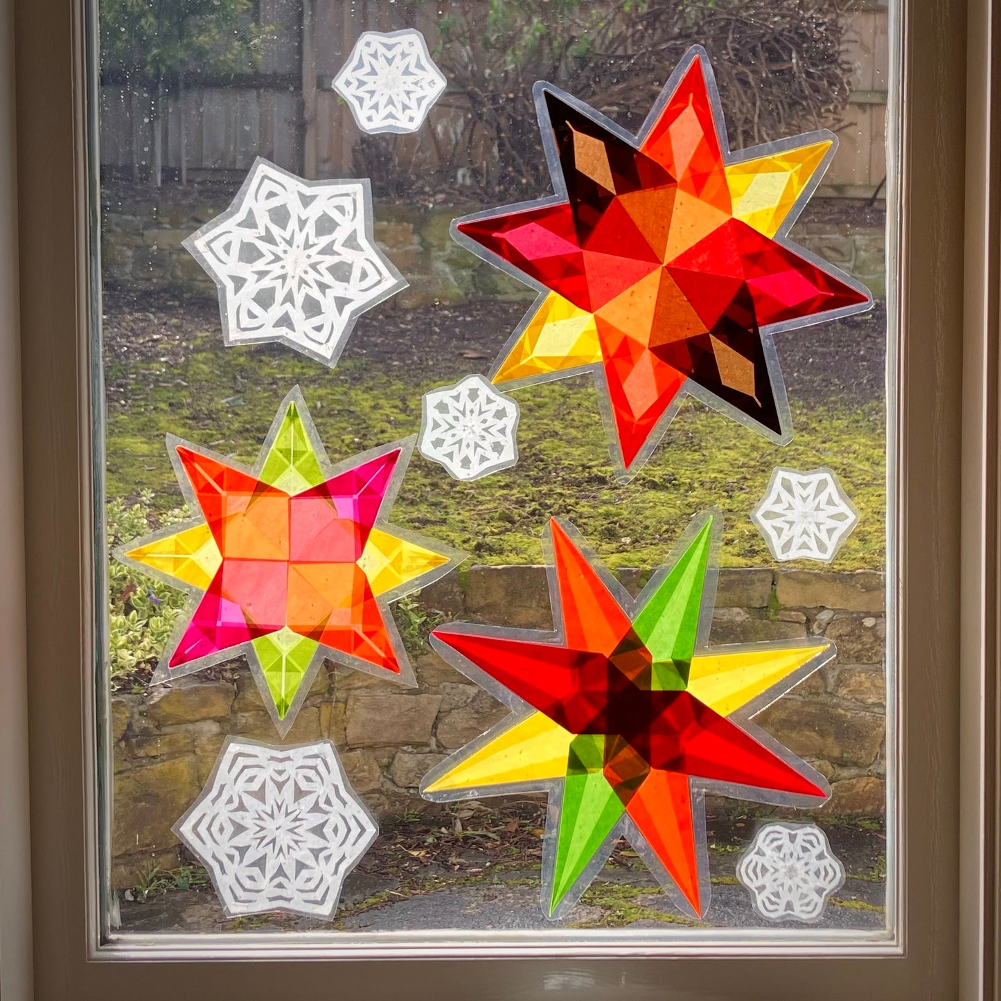 a kaleidescope of kite paper snowflakes cut paper snowflakes and folded paper window stars