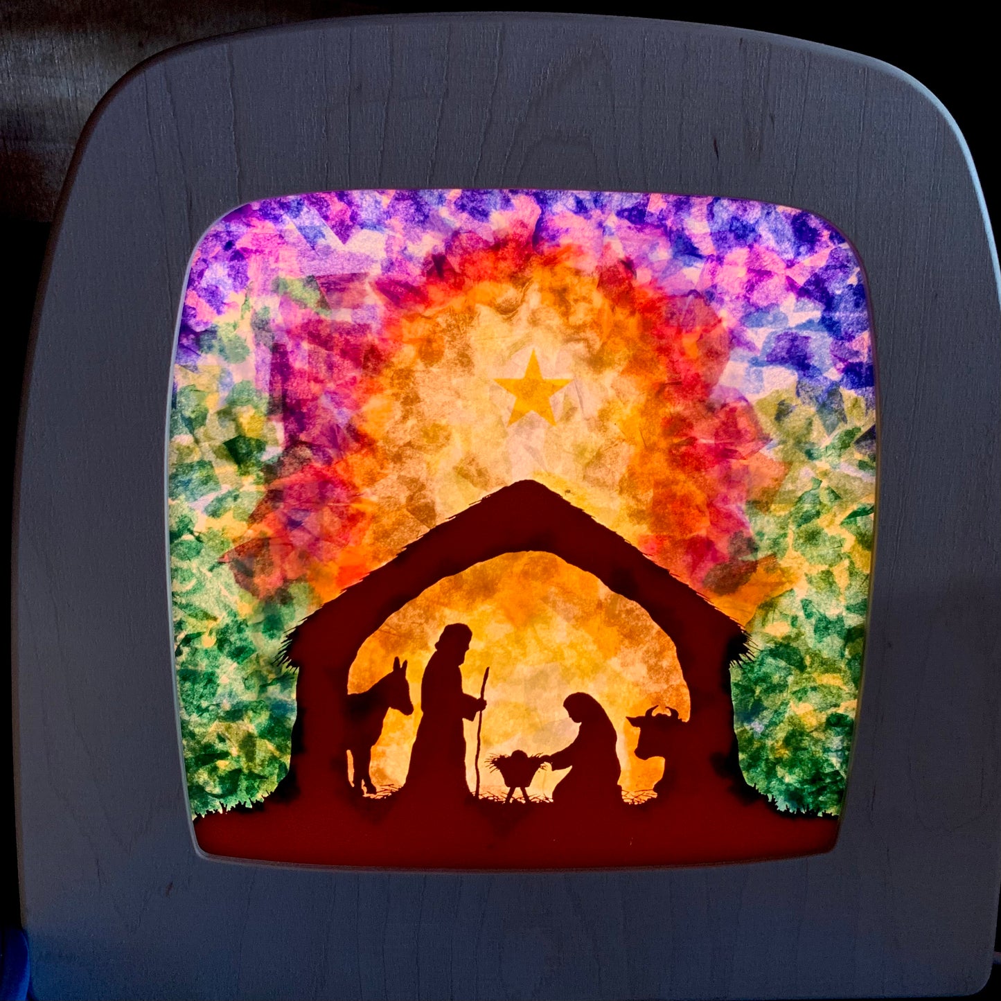 Colourful nativity scene design made with a DIY kit including coloured tissue paper  