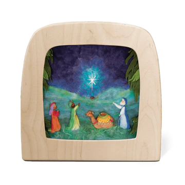 Wooden picture frame with a felted scene of the Nativity on anight sky  backgroundackgroun with guiding star