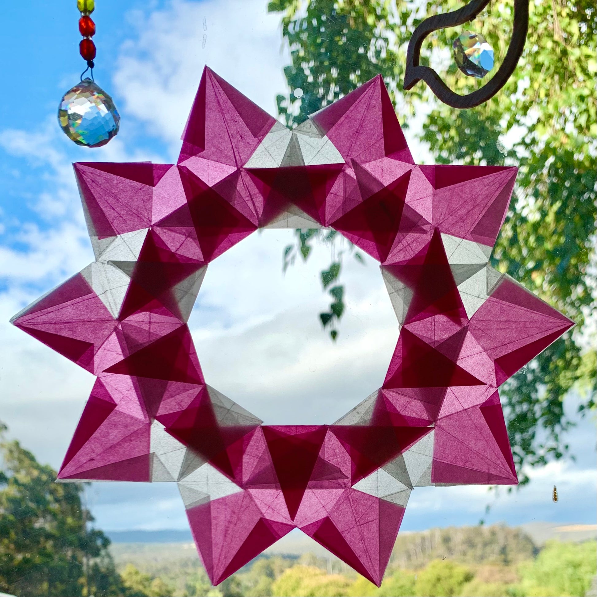 A pretty pink and white kite paper window star wreath made  as a gift for a sick friend